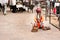 A snake charmer is playing the flute for the cobra sitting on the street near Fort Amber on Dec