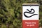 Snake icon with please stay on path text on outdoor sign