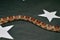 Snake tail on black background with stars