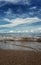 a snap of little wave under blue sky and clean beach like a mirror