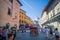 Snapshot showing busy street in Pisa, Italy. Tourist destination place with people, stands selling souvenirs and refreshments