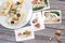 Snapshots of various sandwiches with seafood arranged on rustic wooden background with plates with food and seashells