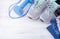 Sneakers, blue dumbbell, jump rope, blue sportswear, on a white wooden background