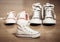 Sneakers canvas shoes of parents and child on wood floor at home in expecting a baby happy family