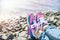 Sneakers girl on background of sea and rocky beach