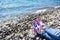 Sneakers girl on background of sea and rocky beach