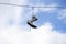 Sneakers hanging on wires on a background of blue sky.