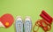 Sneakers, jump rope and wooden rackets for table tennis on a green background