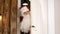 Sneaking Santa Claus secretly entering the living room