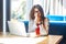 Sneeze, cold, influenza or allergies. Portrait of sick stylish brunette young woman in glasses sitting holding tissue napkin and