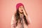 Sneezing. Cold climate weather. Little girl sick ill pink background. Kid puffer jacket and knitted hat. Winter cold flu