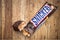 Snickers chocolate bar on wooden background