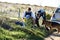 Sniffing out a suspect. Shot of two investigators taking notes while examining a body at a crime scene.