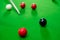 Snooker balls on the green table for playing entertainment of man