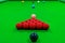 The snooker balls on the table consist of red, black, pink, blue, green, white, brown, and yellow, the focus is on the red ball