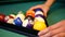 Snooker or billiard. In a billiard club or a night club a man puts billiard balls on a pool table, game is going to begin