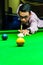 Snooker player placing the cue ball for a shot