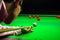 Snooker player placing the cue ball for a shot