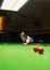 Snooker player placing the cue ball for a shot