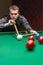 A snooker player showcases intense focus and precision with skill, strategy, and concentration