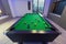 Snooker Pool Billiards green table with complete set of balls in a middle of a game in a modern games room