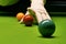 Snooker table and balls with referee arranging the balls