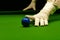 Snooker table and balls with referee arranging the balls