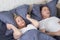 Snoring man. Couple in bed, man snoring and woman can not sleep, covering ears with pillow for snore noise. Middle age