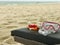 Snorkel and diving mask on a deckchair on a white sand beach