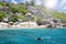 A snorkeler at an island coral reef with turtle. Seychelles.