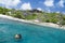 A snorkeler at an island coral reef with turtle. Seychelles.