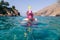 Snorkeler in pink mask, snorkeling man in full face mask, summer vacation activity, swimming in the warm tropical sea, seashore