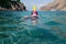 Snorkeler, snorkeling man in full face mask, summer vacation activity, swimming in the warm tropical sea, seashore and fishes,