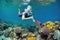 snorkeler with underwater camera exploring colorful reef