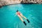 Snorkeling details, woman looking at coral reef in tropical island