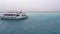 Snorkeling and scuba diving on the background of tourist yachts near white sandy island. Egypt