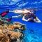 Snorkeling in the tropical water with camera
