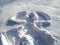 Snow angel design made in fresh, deep snow, by lying on back and moving arms up and down, and legs from side to side