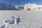 Snow angel made in snow on a frozen mountain lake in winter