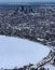 Snow art: Aerial view city blanketed with snow in winter  covering recreational area or park in the foreground.