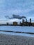 Snow art: Smoke from a coal fired power plant in winter against the blue sky