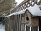 Snow on bird houses on wood fence