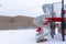 Snow blanketing a park with benches and slides on a cold winter landscape