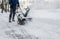 Snow blower in action clearing a residential driveway after snow storm