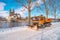 Snow blower machine is cleaning a road from snow along Elbe river and Cathedral in historical downtown in Winter at blue sky and