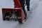 Snow blowing a driveway on a blustery winter day