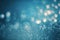 Snow blurred bokeh light gloving backdrop. White snowflakes defocused winter background. Blue shiny particles gradient