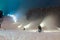 Snow cannons working at night in the mountains