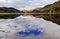 Snow caped Yr Aran and winter coloured snowdonia foothills reflected in Llyn Gwynant