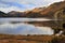 Snow caped Yr Aran and winter colours of snowdonia foothills reflected in Llyn Gwynant